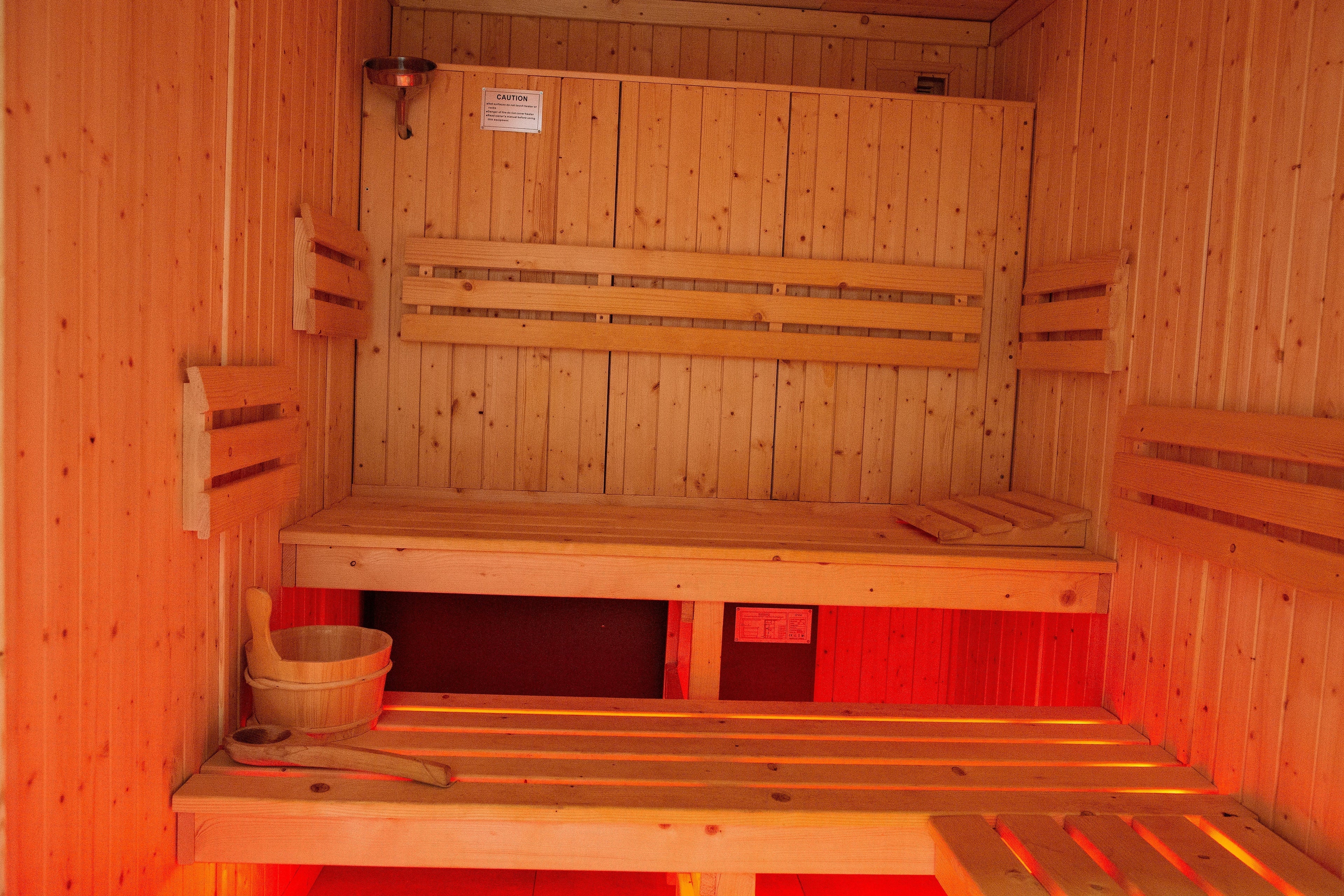 Luxury wooden sauna room at Rinto Fitness Richmond for post-workout recovery and relaxation.